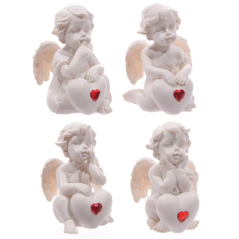 Cute seated cherub figurine with a red heart gem, made of resin.
