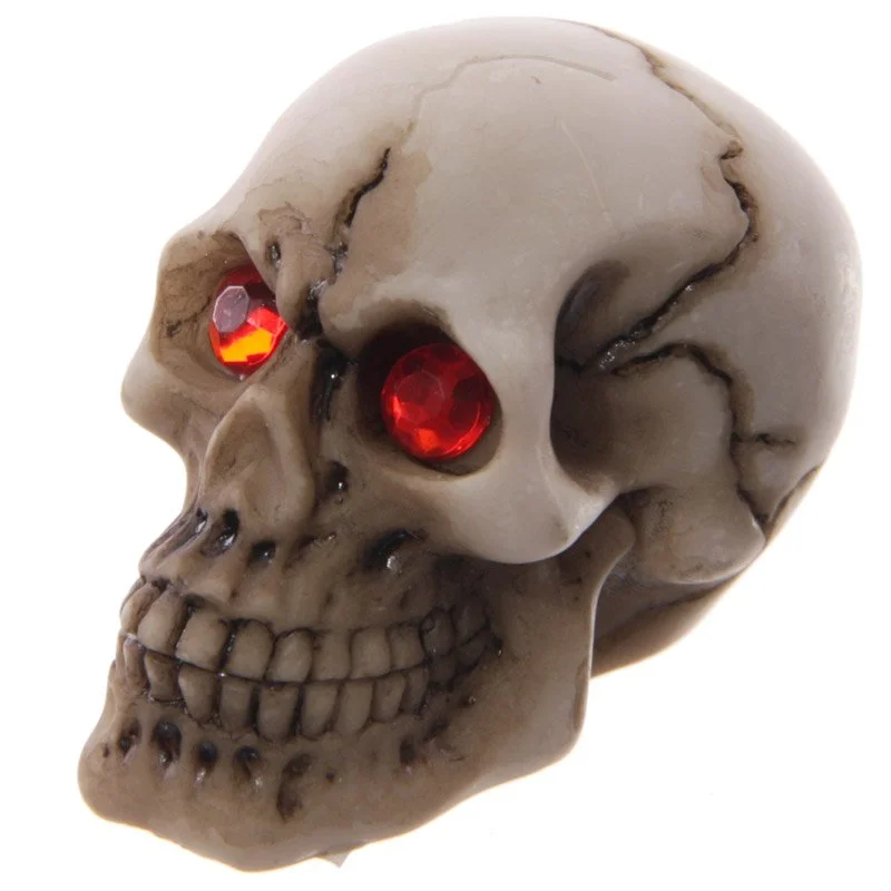 Red skull decoration made from resin, featuring stylised eyes, produced in China.