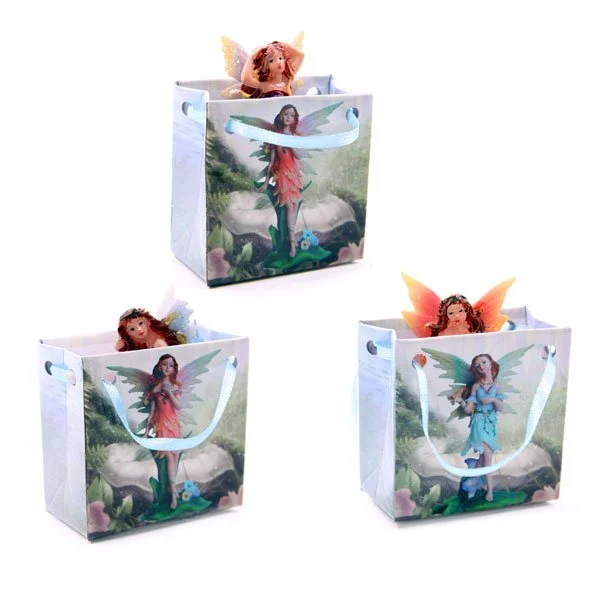 Cute mini flower fairy figurine in resin, packaged in a small card gift bag with ribbon handles.