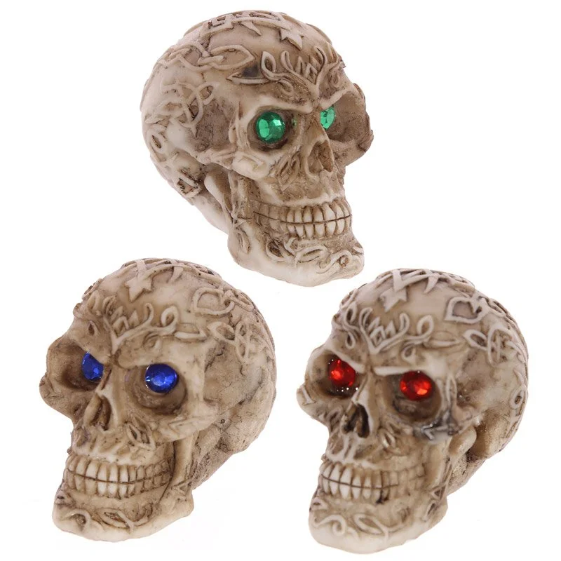 Mini resin gothic skull ornament with gem eyes, made in China, featuring jewel‑like black and white eyes.