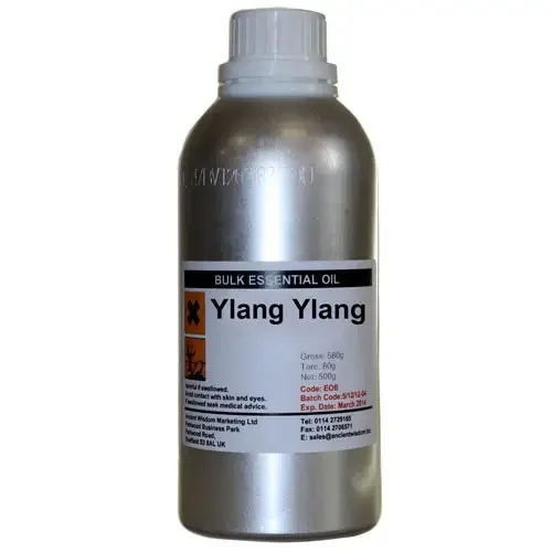 Clear glass bottle of ylang ylang essential oil, 0.5kg, with label and cap.