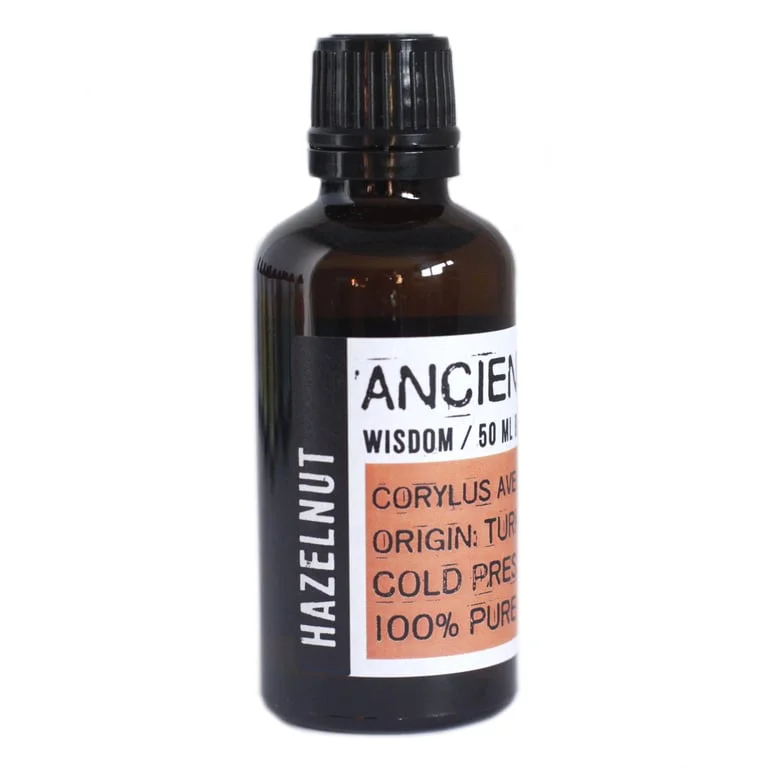 Clear glass bottle of hazelnut oil 50ml, featuring a dark amber liquid and a white label.