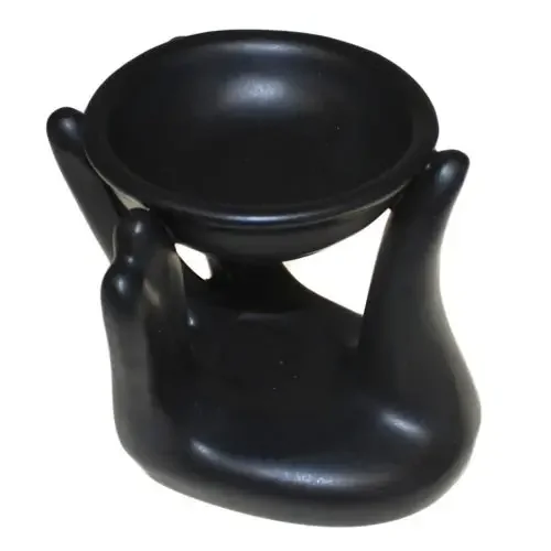 Black helping hand oil burner, slender metal design with subtle curves and a small decorative insignia