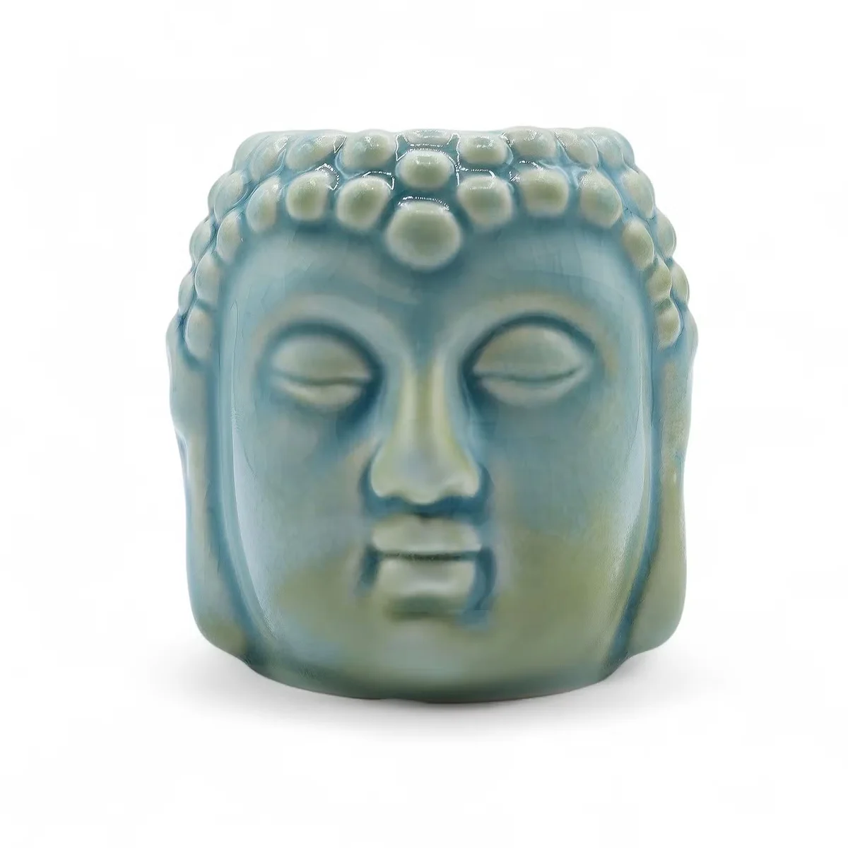 Blue Buddha ceramic oil burner resting on a dark background, positioned to show its smooth surface and simple design.