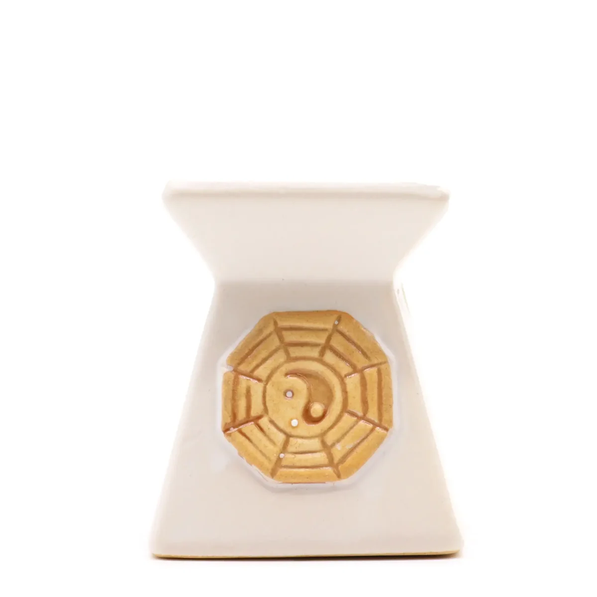 Classic yin yang oil burner in elegant black and white design on a simple stand.