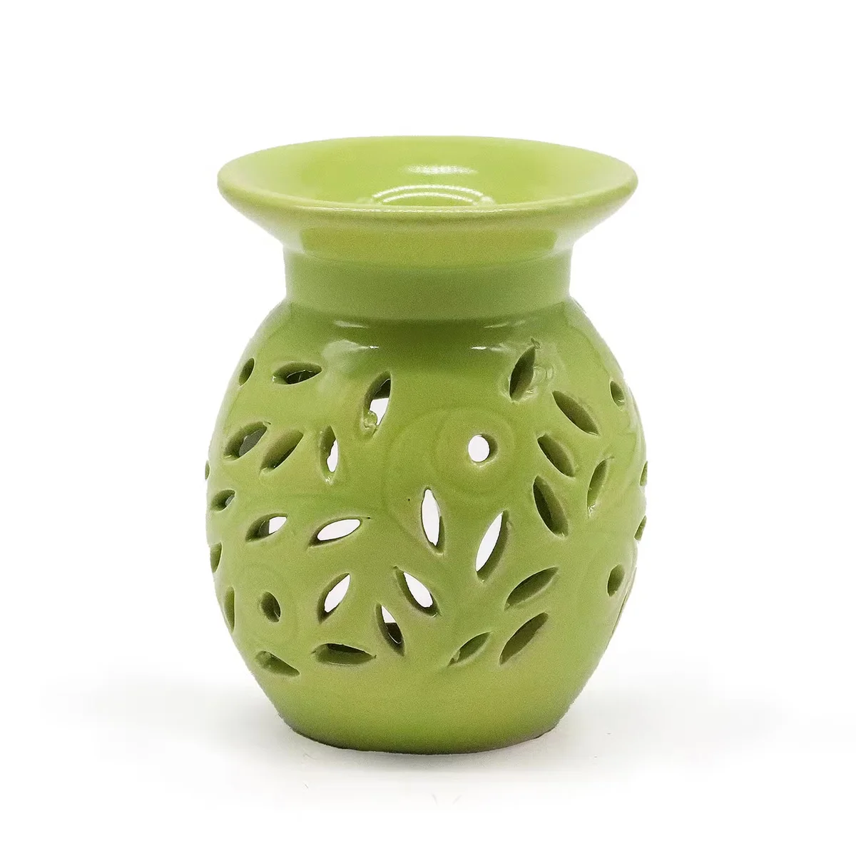 Oil burner floral in lime shade resting on a wooden surface