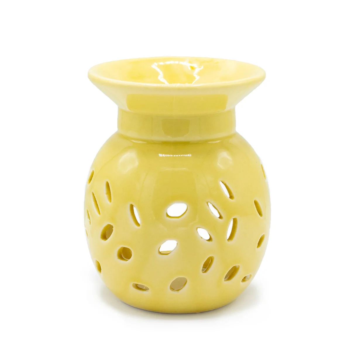 A floral patterned yellow oil burner on a wooden surface