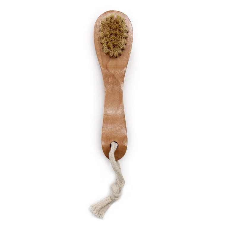Serious scrub brush with compact handle and soft bristles for face cleansing.