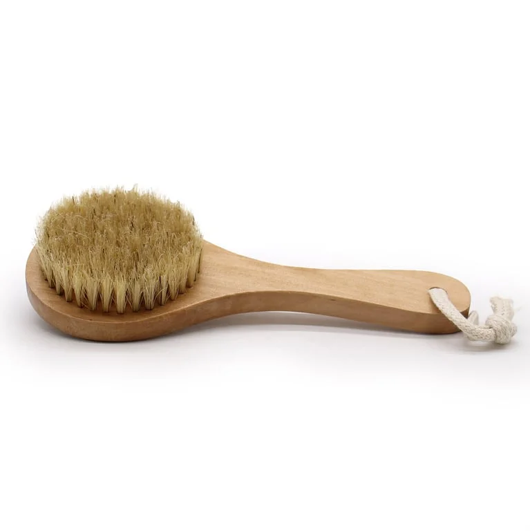 Body scrub brush with short handle, featuring densely packed bristles for exfoliation.