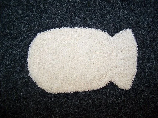 Bamboo washing mitt with rounded handle shown from the front.