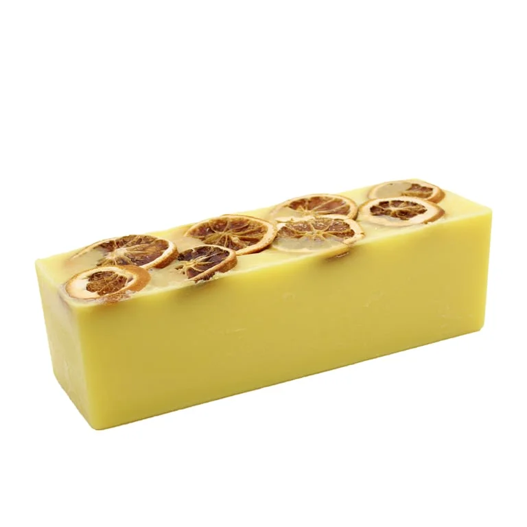 Slice of Sunshine soap loaf displayed on a bright background
