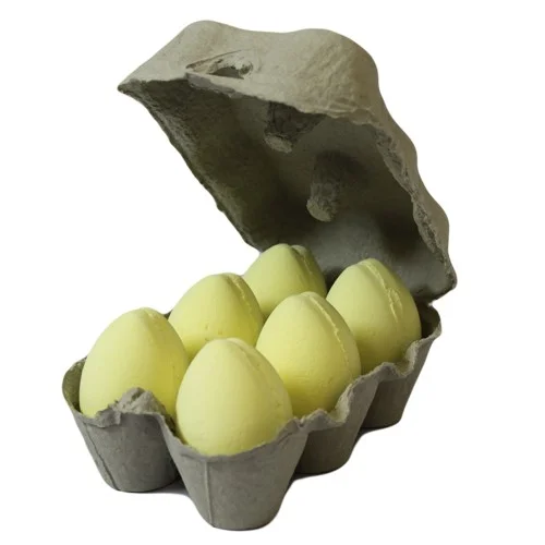 Tray of packaged banana bath eggs, each egg shaped like a banana, displayed together.