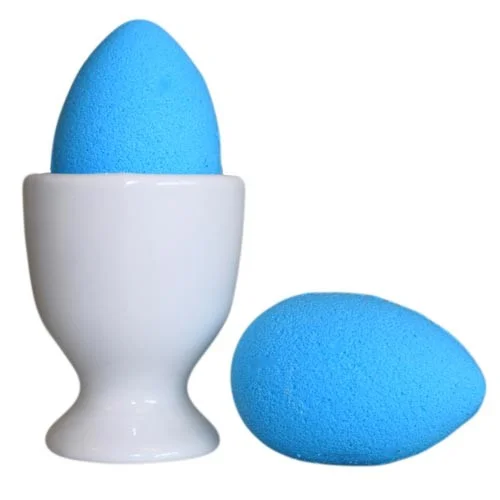 Blueberry scented bath eggs arranged on a bath eggs tray, bright blue and purple fruit motifs.