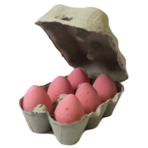 Tray of scented bath eggs in cherry shade, neatly arranged on a wooden tray.