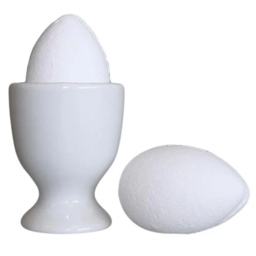 Tray of bath eggs scented with coconut, displayed neatly on a wooden tray.
