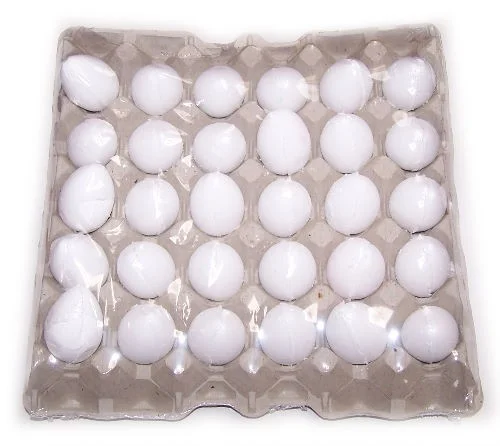 Tray of coconut bath eggs arranged in a clear glass container.