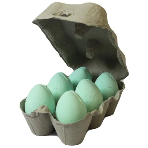 Tray containing mango bath eggs arranged in a square pattern.