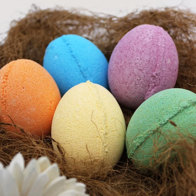 Tray of tangerine and grapefruit coloured bath eggs displayed on a white surface, bath eggs uk