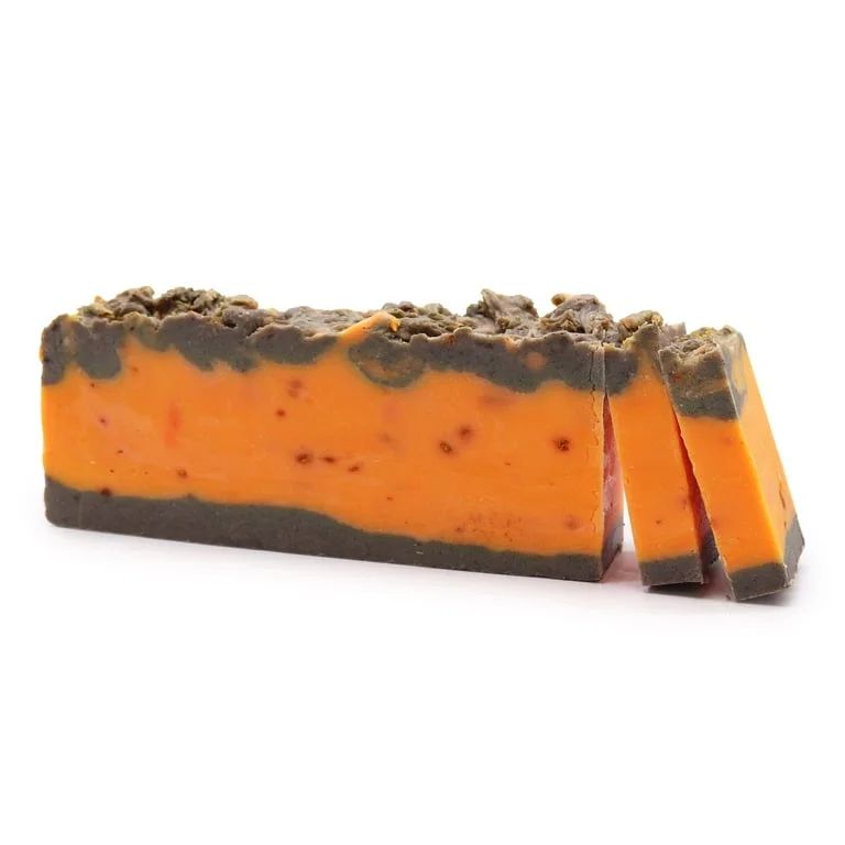 Hand‑made cinnamon orange soap loaf in olive oil, rectangular block with light brownish texture and orange zest accents.