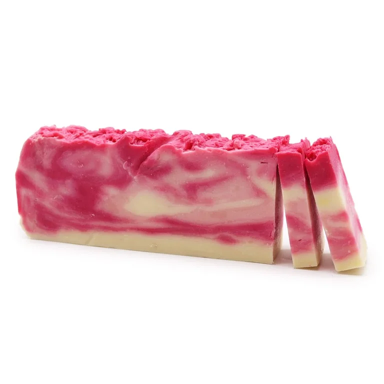 Loaf of rosehip olive oil soap, natural light brown texture with subtle orange hues.