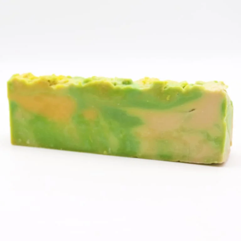 Loaf of Noni olive oil soap with a natural brown finish and textured surface.