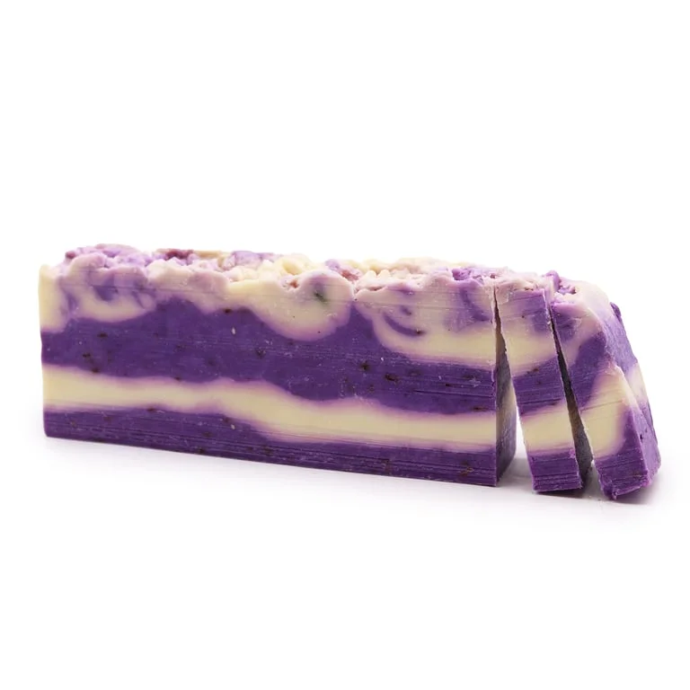 Loaf of lavender olive oil soap, pale purple bar with a textured, rustic appearance.