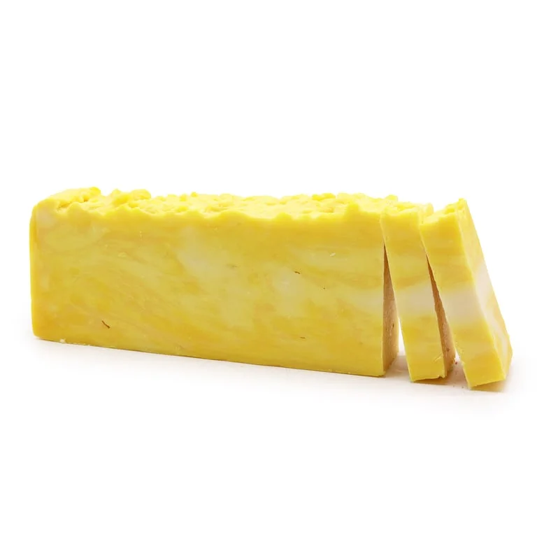 Olive oil soap loaf scented with lemon, shown cut into generous slices with natural brown glaze.