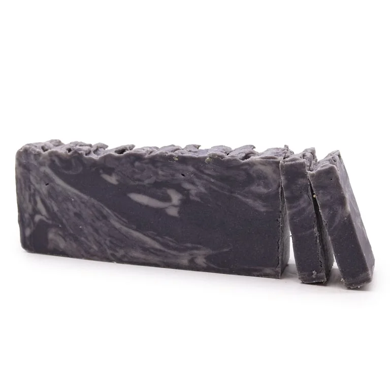 Olive oil soap loaf made with dead sea mud soap, displayed on a simple background.