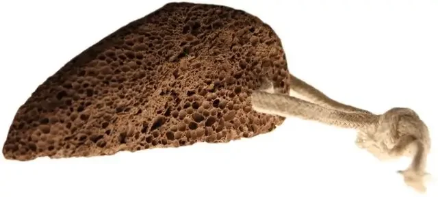 Traditional foot stone: volcanic stone in classic shape, rough textured surface, rugged appearance