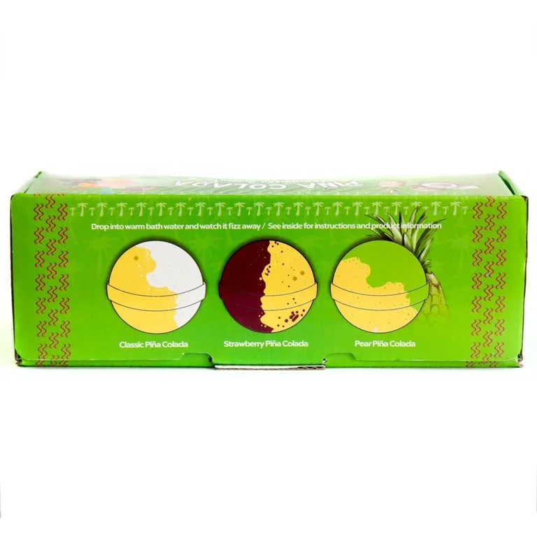 Three frosted glass bath bombs in piña colada scent, arranged on a sandy background.