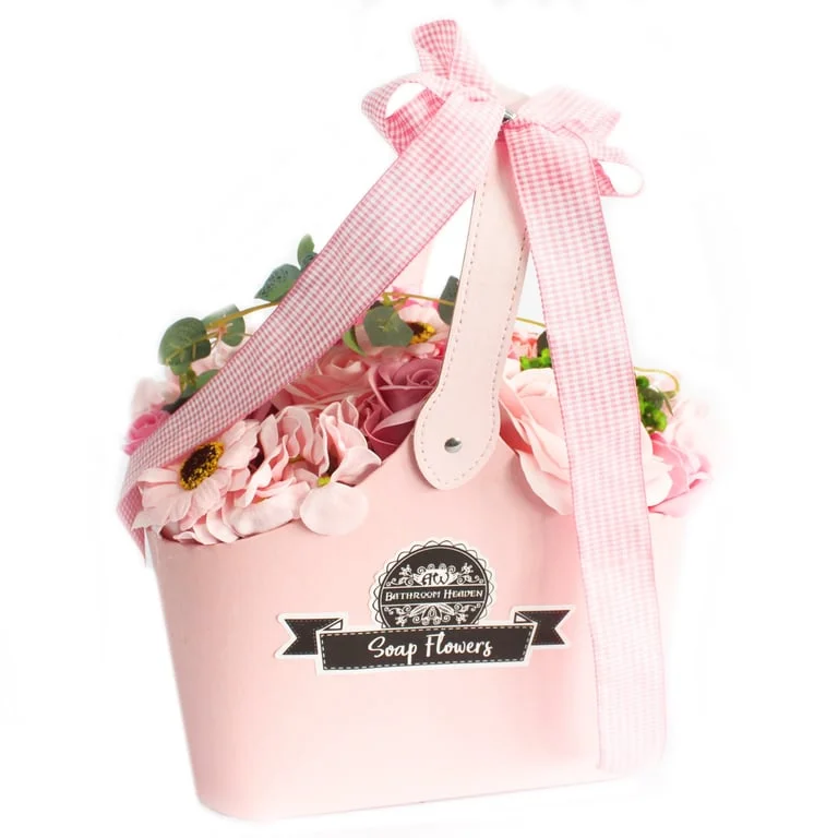 pink soap flower bouquet displayed in a woven basket