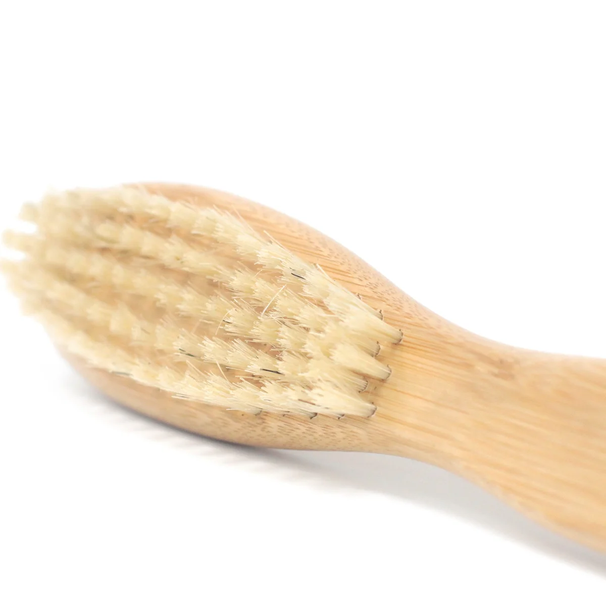 Beard care brush displayed on a flat surface.