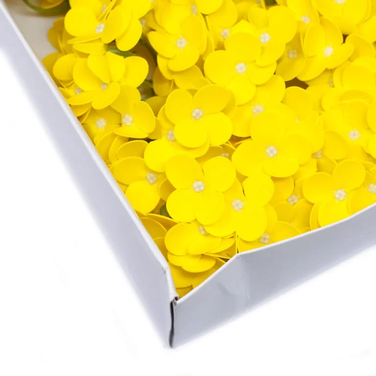 Yellow hyacinth bean soap flower with translucent petals and soft green stems, crafted as a decorative soap bloom.