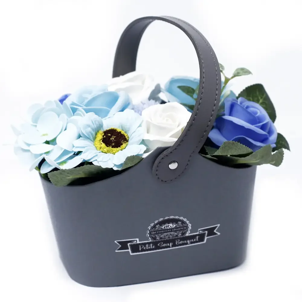 Petite basket in soothing blue holding a fresh bouquet