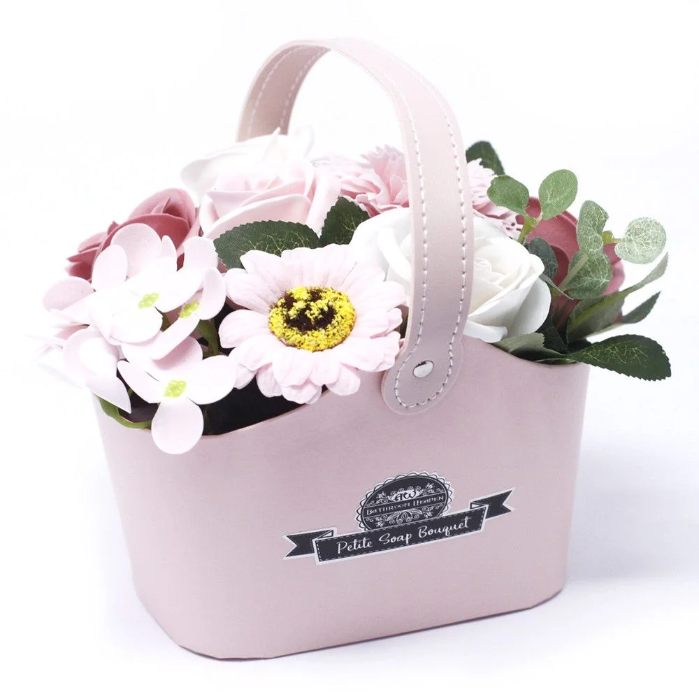 Peaceful pink basket filled with fresh flowers, a small bouquet displayed in a miniature basket