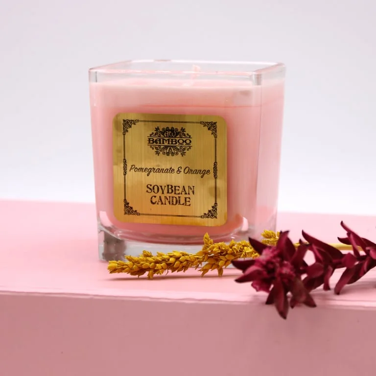 Soybean candle scented with pomegranate and orange, displayed on a simple white background.