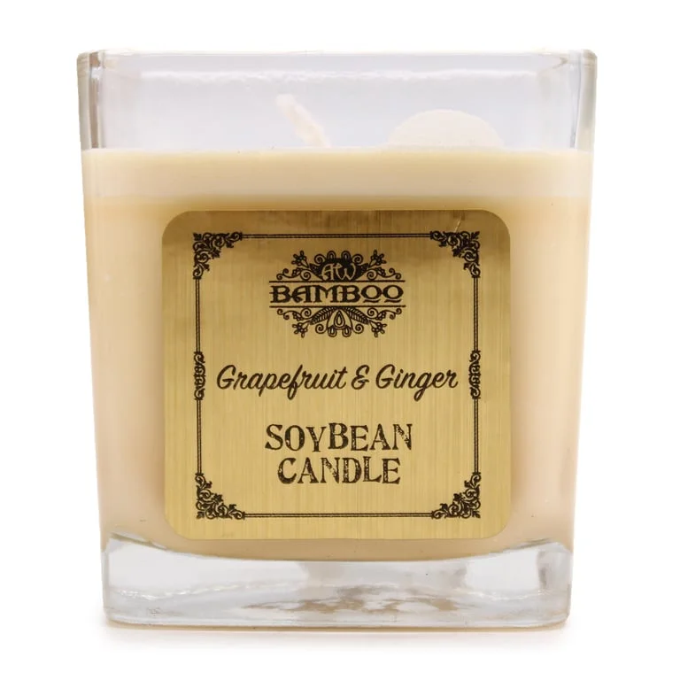 Soybean jar candle showing a translucent glass jar with a label, a lit candle flame, and subtle grapefruit and ginger aroma.