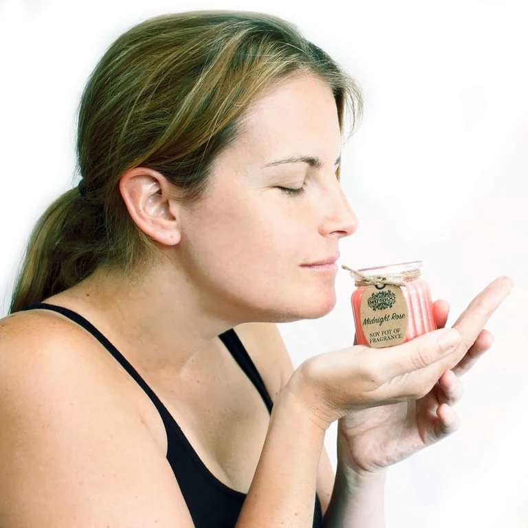 Fragrance soy candle in a linen‑coated pot, nestled on a wooden tabletop