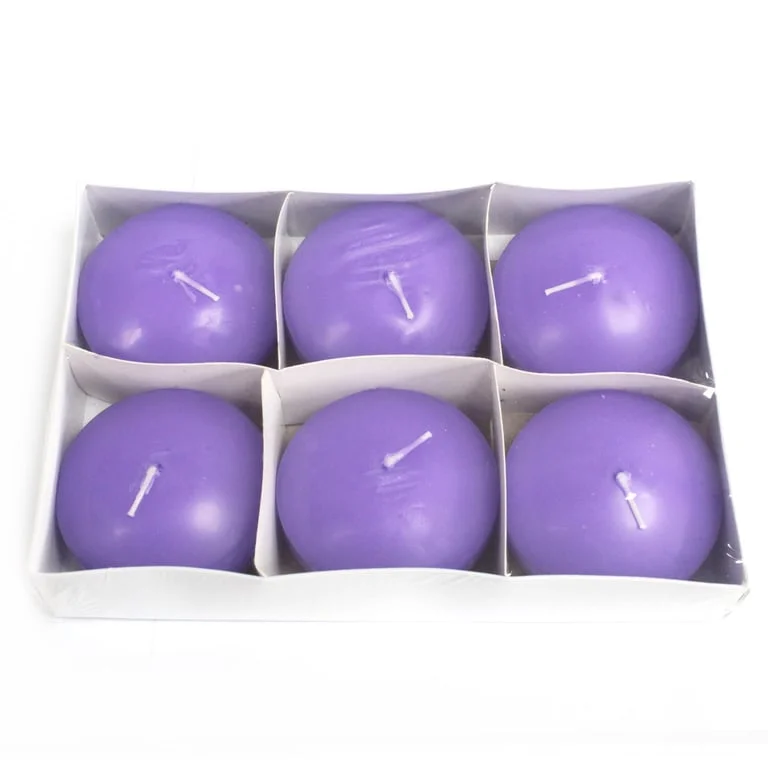 Lilac floating candle resting on a glass surface, showcasing its soft purple hue and elegant simplicity.