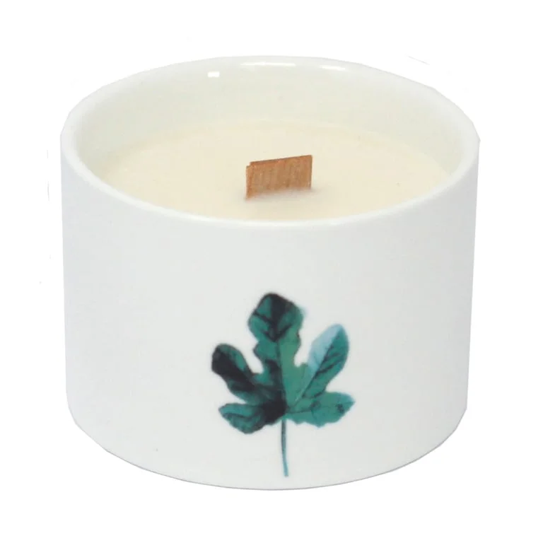 Med botanical candle displayed on a stone base with a Japanese Garden design backdrop.