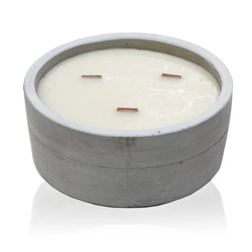 Large round patchouli candle in deep dark amber with a subtle glow