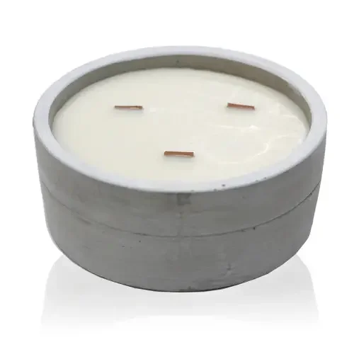 Large round dark amber candle with patchouli scent.