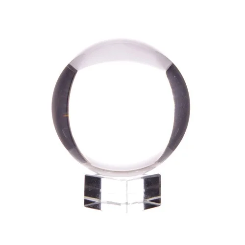 Crystal ball on stand displays a clear glass sphere atop a simple base.