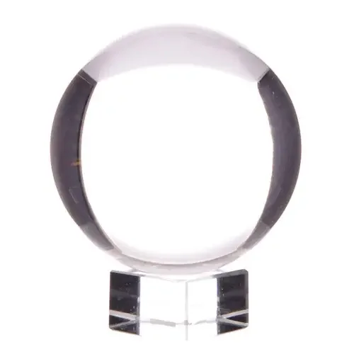 Crystal ball resting on polished stand, featuring crystal ball decor.