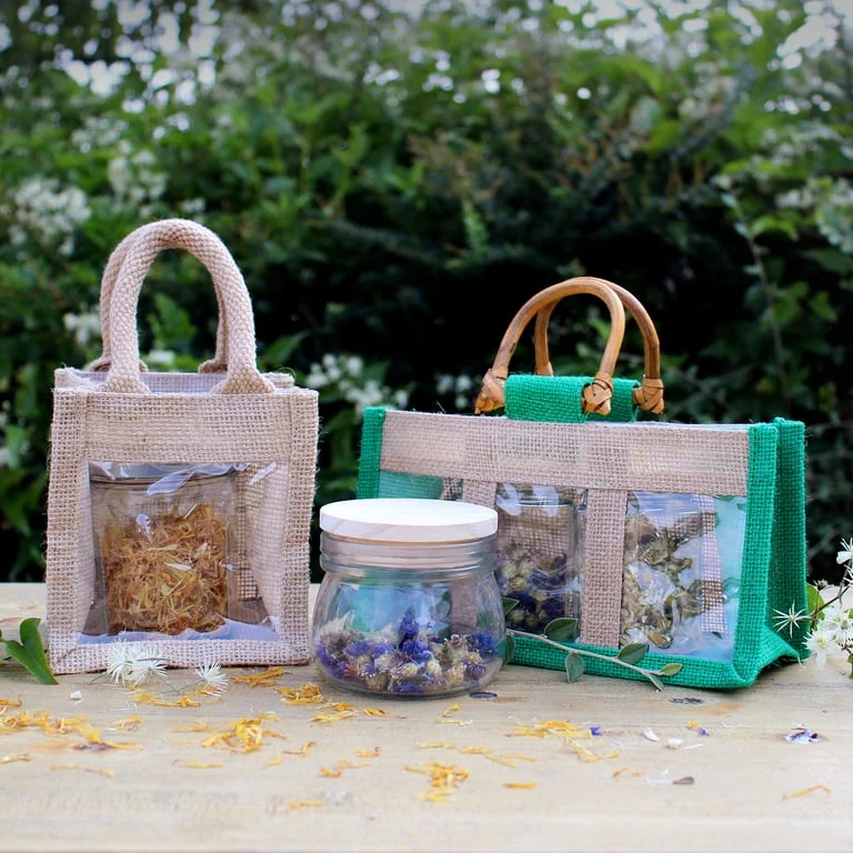 Clear window jar in a simple gift bag, measuring 12x12x13cm, showing the jar’s side view through the bag.