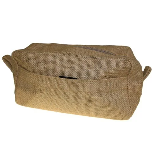 Natural jute toiletry bag open with travel toiletries inside on a wooden surface.