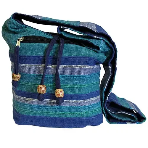nepal sling bag in blue rivers pattern, slung across a shoulder