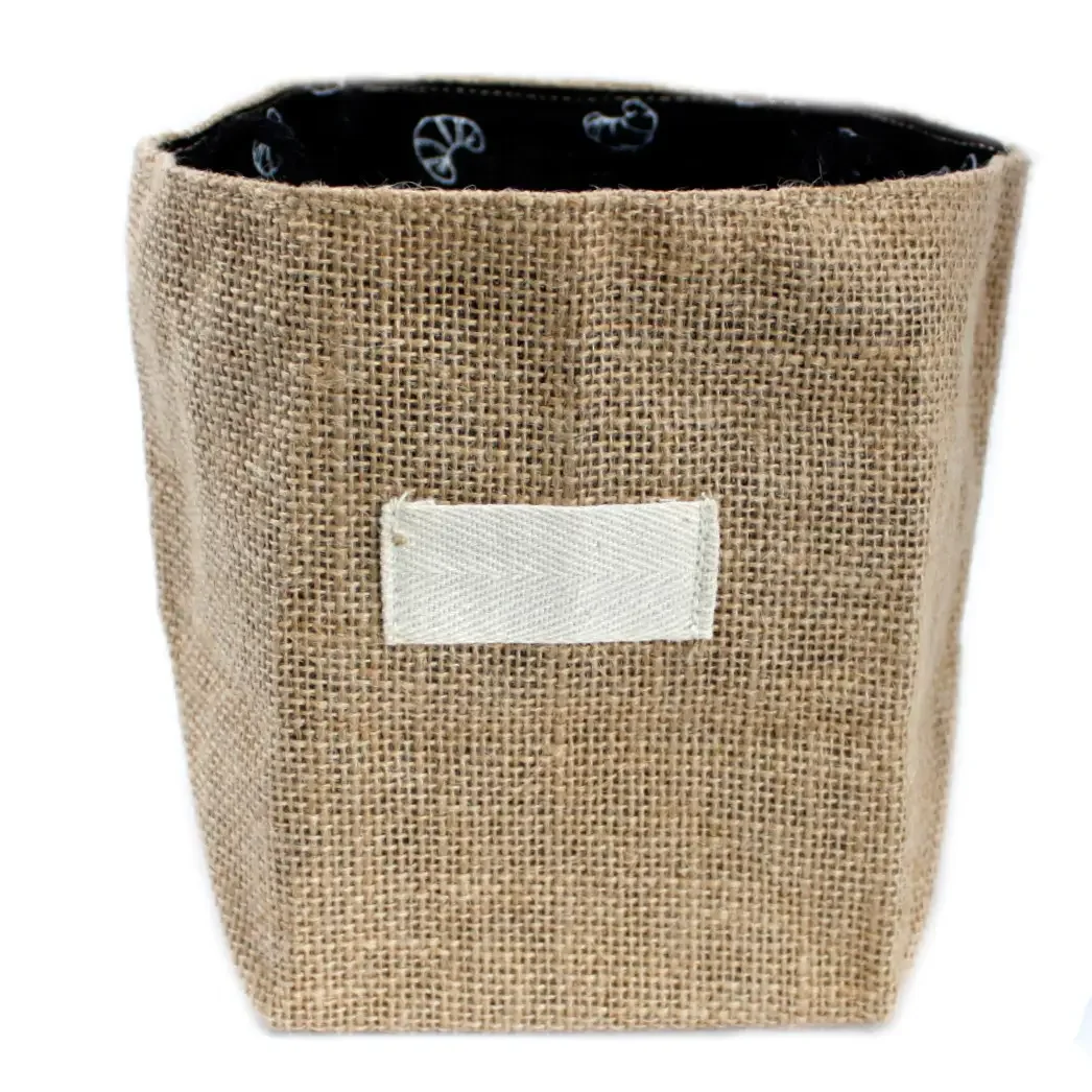 Large natural jute bag with black lining, stitched cotton lining visible, airy open design.