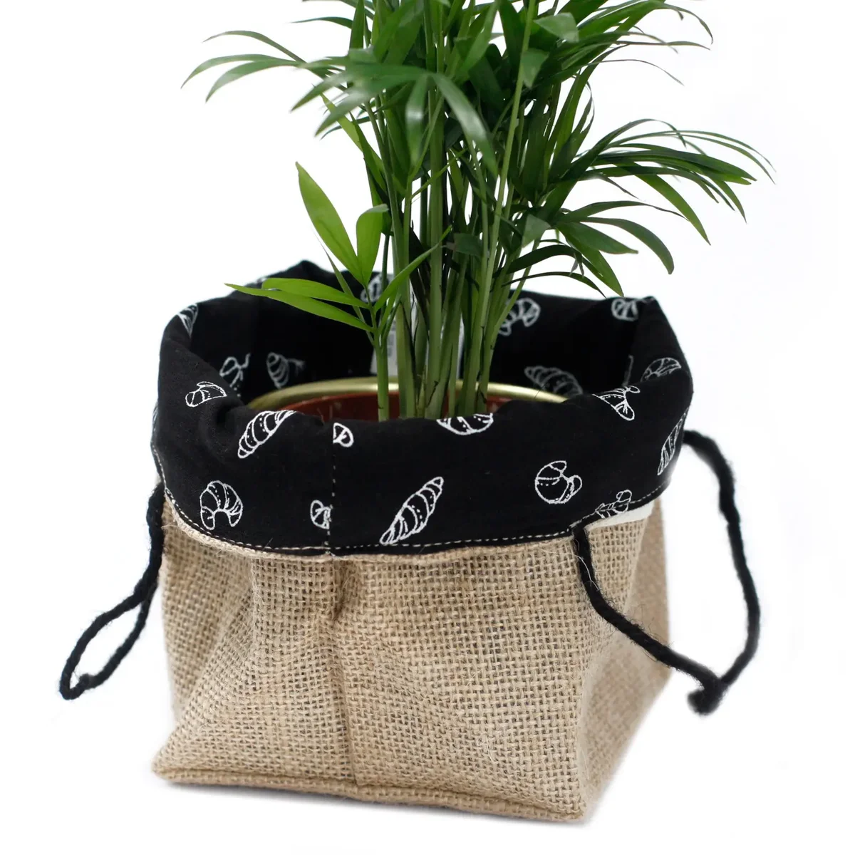 Medium natural jute bag with black lining, showing woven cotton material and sturdy handles.