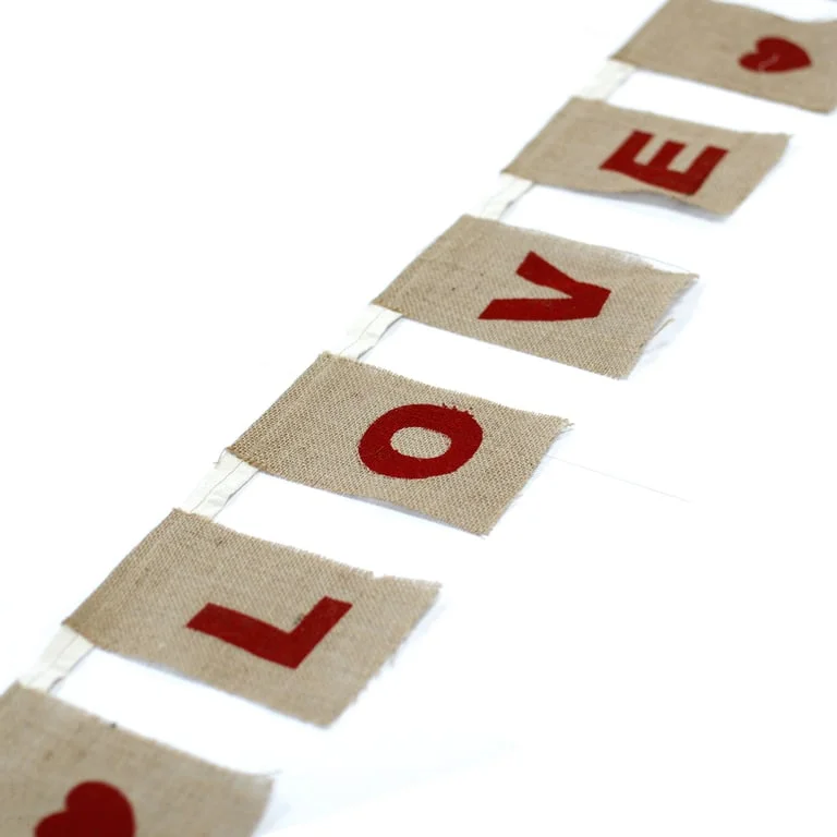 Natural decorative bunting with large I LOVE YOU hearts design in natural colour fabric.